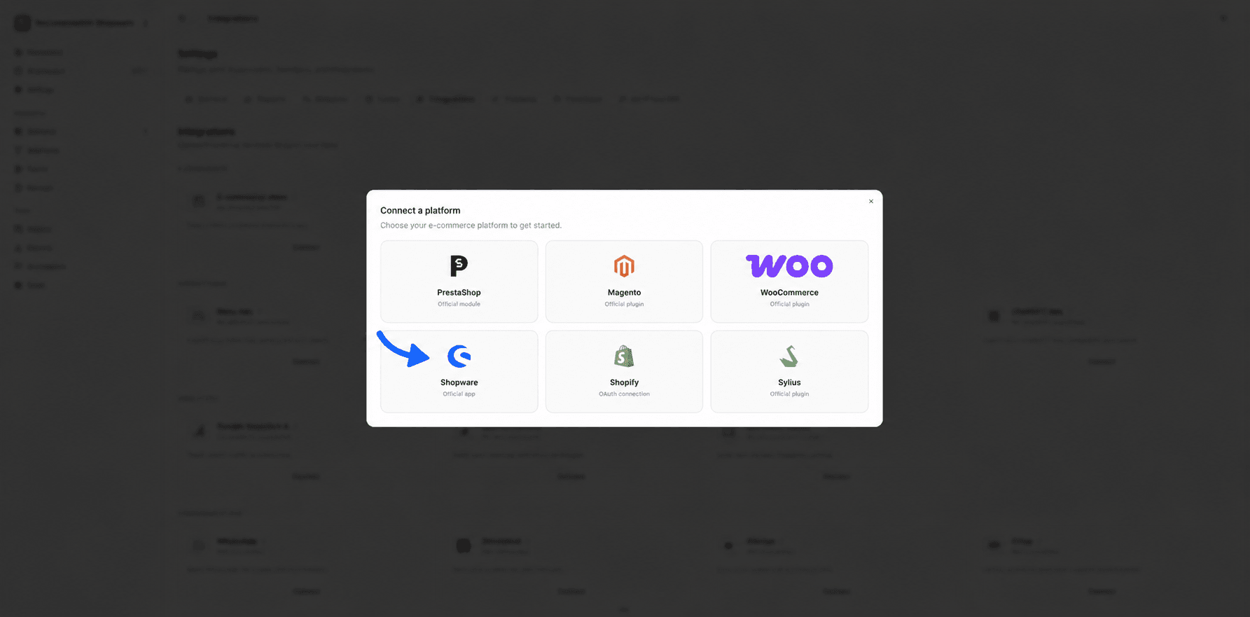 Fullmetrix Integrations page in English and light mode with the six-card platform dialog and a blue arrow pointing to the Shopware official app